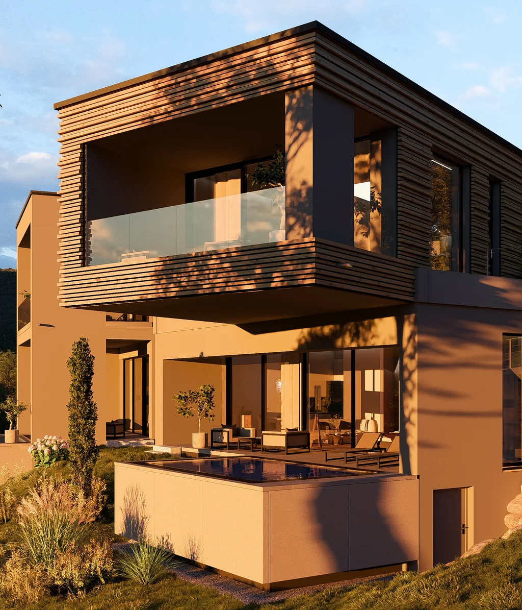 Cubea | Chalet-Apartments in Bodenmais für hohe Ansprüche Modernes Haus mit Holzverkleidung und Terrasse in grüner Landschaft bei Sonnenuntergang